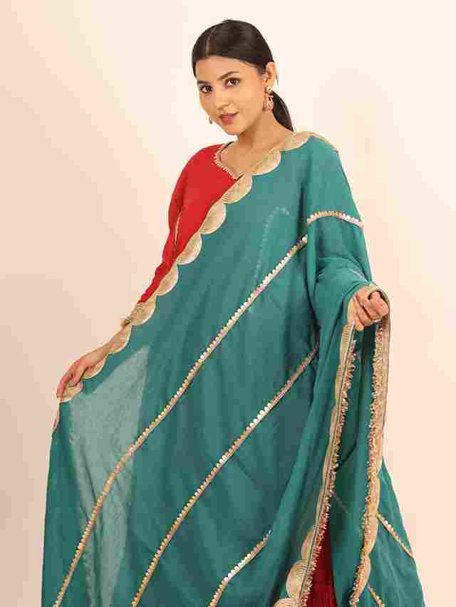 A model showcasing Red Flared Suit by Adivaa from Adivaa's collection