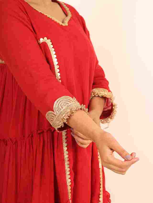 A model showcasing Red Flared Suit by Adivaa from Adivaa's collection