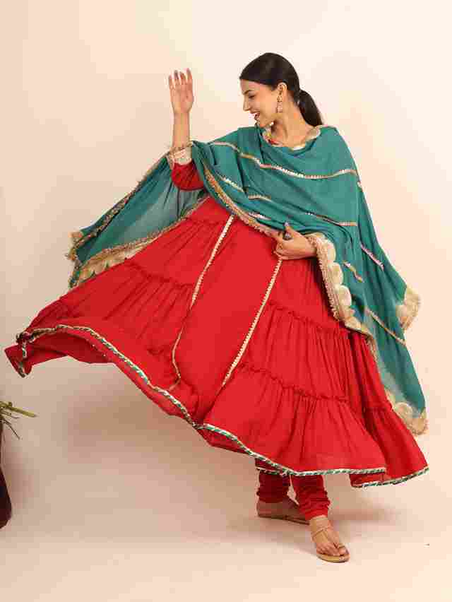 A model showcasing Red Flared Suit by Adivaa from Adivaa's collection
