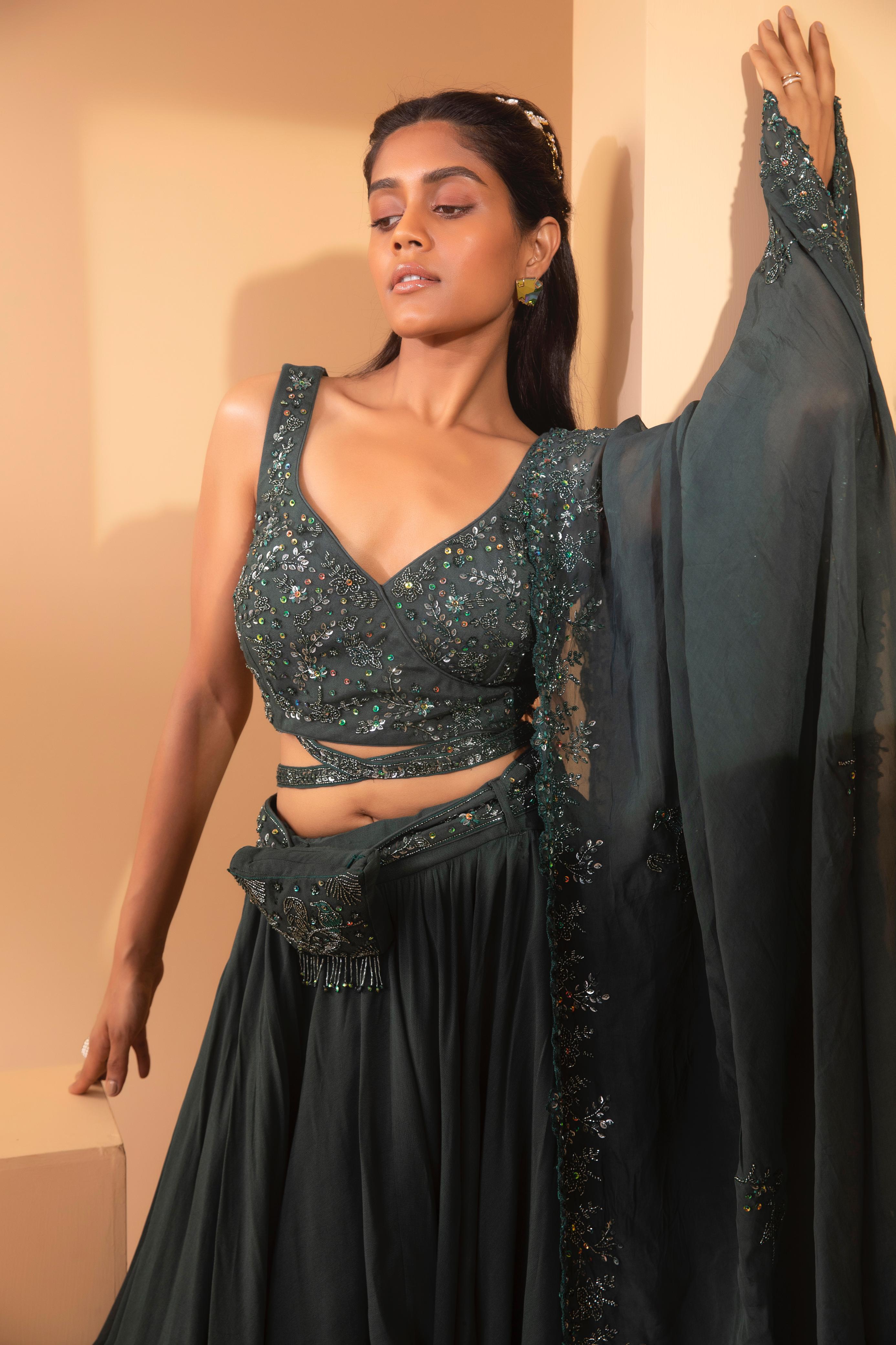 A model showcasing Alnitak Cross Belt Lehenga by Miku Kumar from Miku Kumar's collection