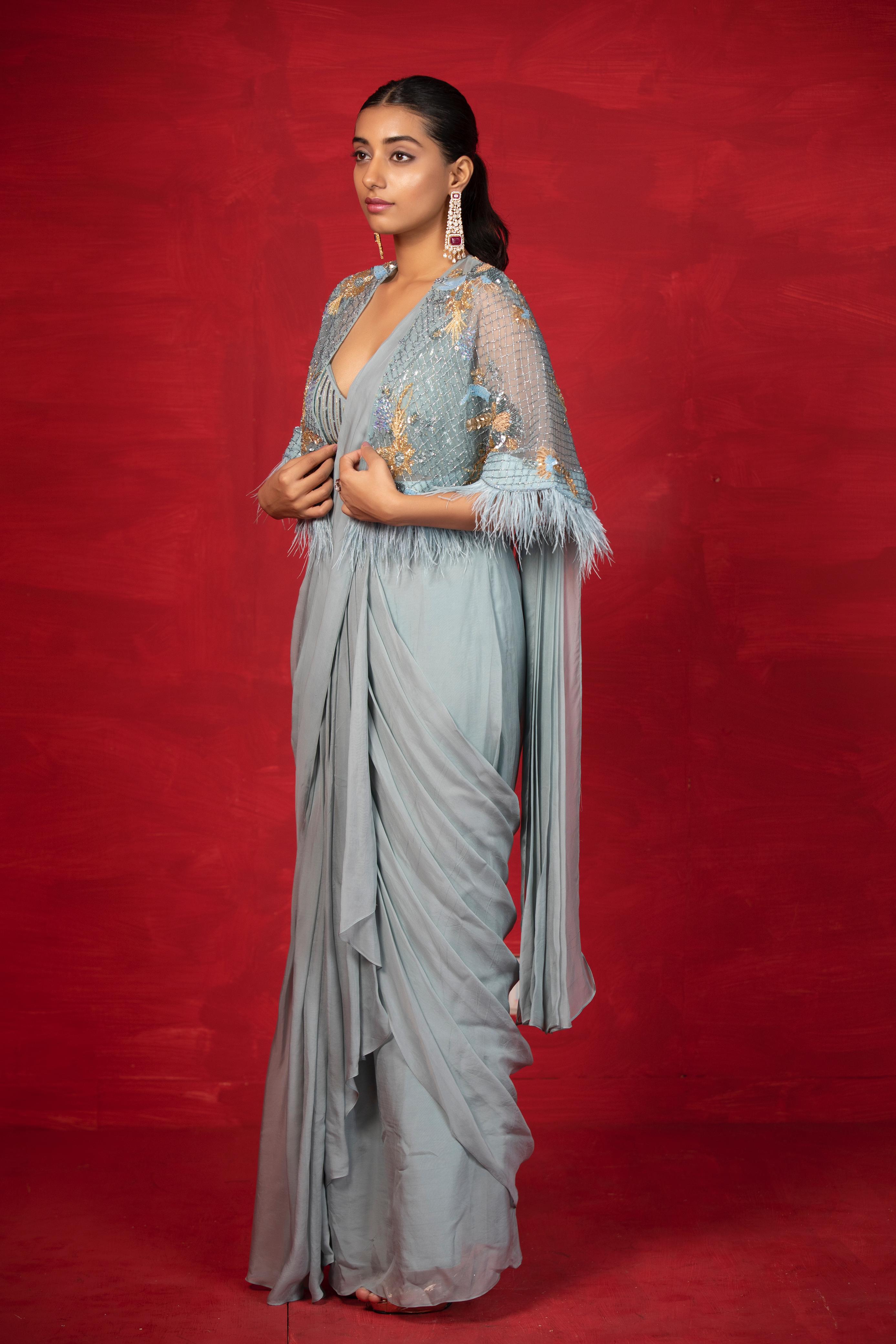 A model showcasing Casa Feathers Cape Saree by Miku Kumar from Miku Kumar's collection