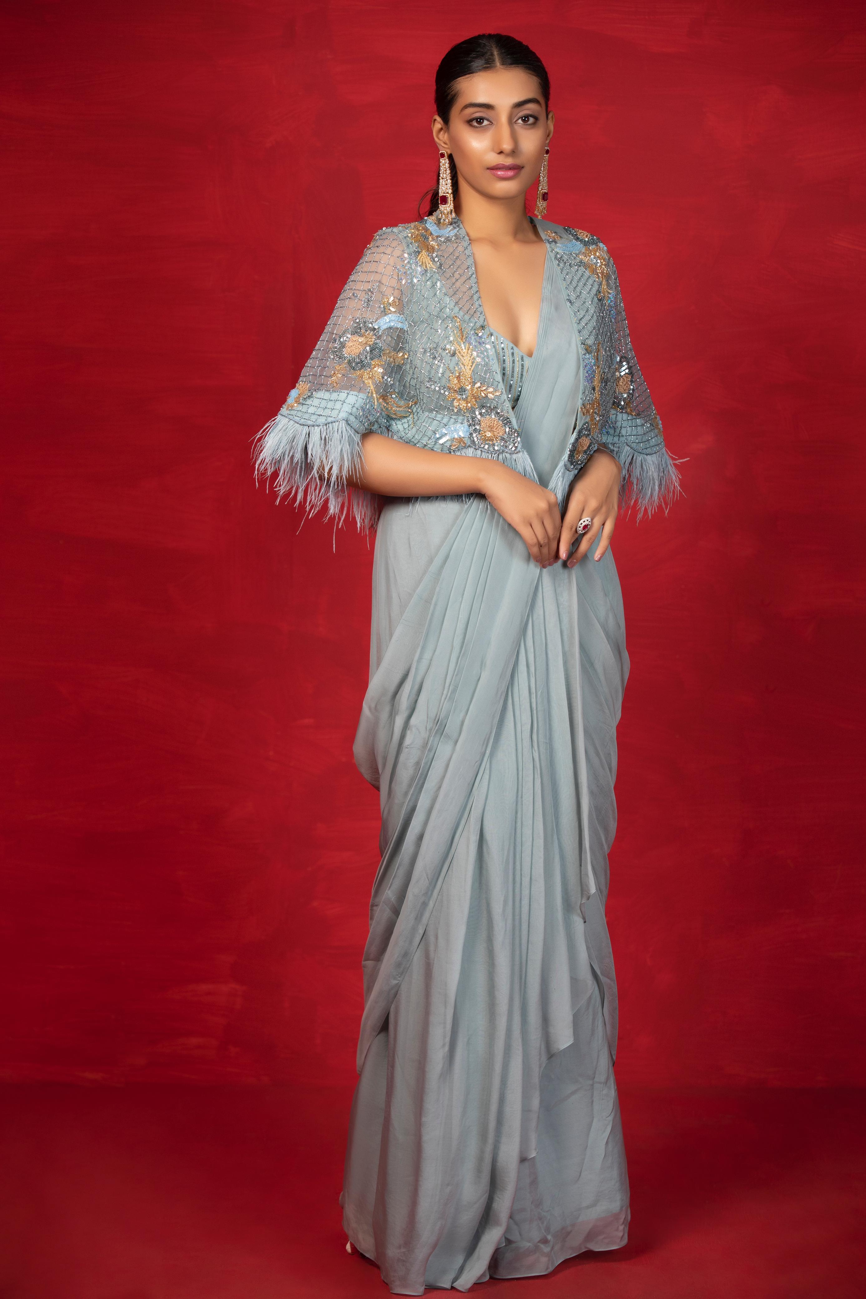 A model showcasing Casa Feathers Cape Saree by Miku Kumar from Miku Kumar's collection
