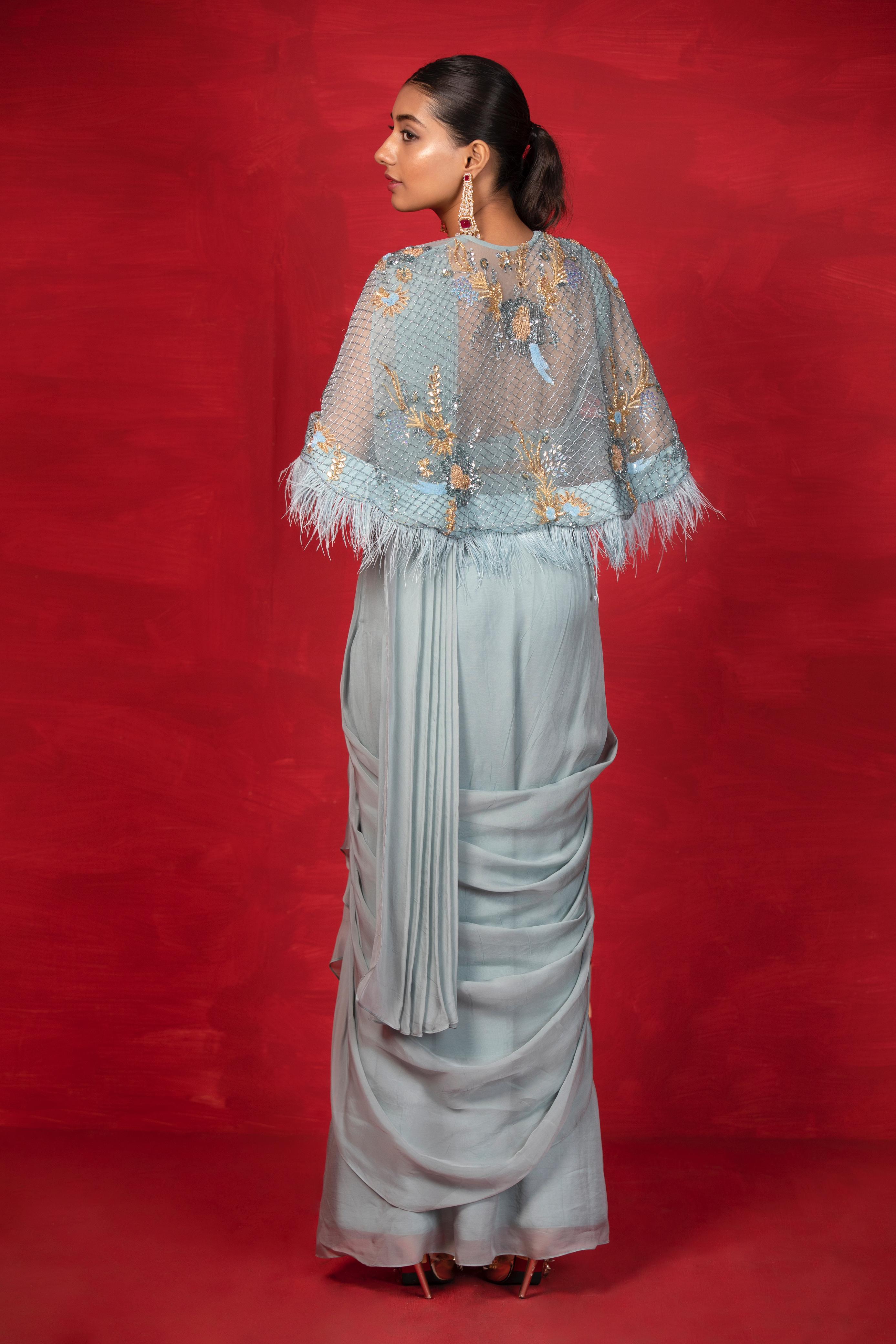 A model showcasing Casa Feathers Cape Saree by Miku Kumar from Miku Kumar's collection
