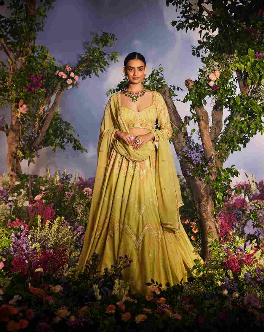 A model showcasing Kyomi Lehenga Set by Miku Kumar from Miku Kumar's collection