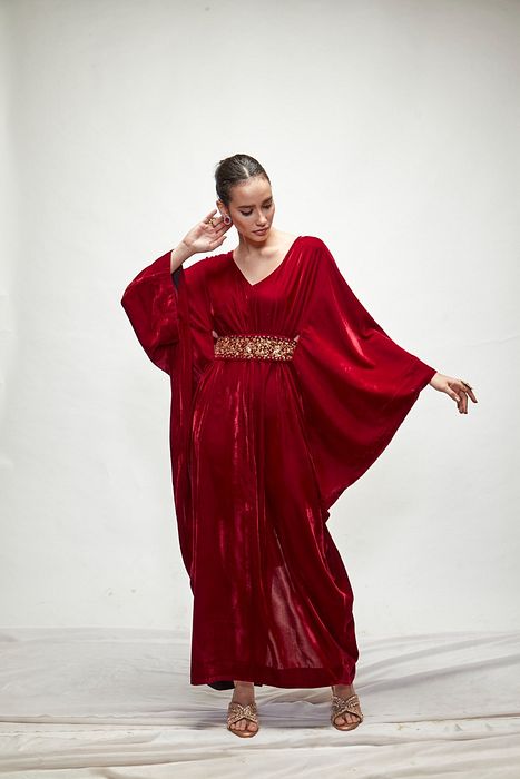 A model showcasing Mahroon Velvet Kaftaan by Ranian from Ranian's collection A model showcasing Mahroon Velvet Kaftaan by Ranian from Ranian's collection