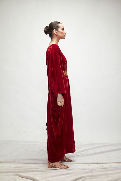 A model showcasing Mahroon Velvet Kaftaan by Ranian from Ranian's collection A model showcasing Mahroon Velvet Kaftaan by Ranian from Ranian's collection