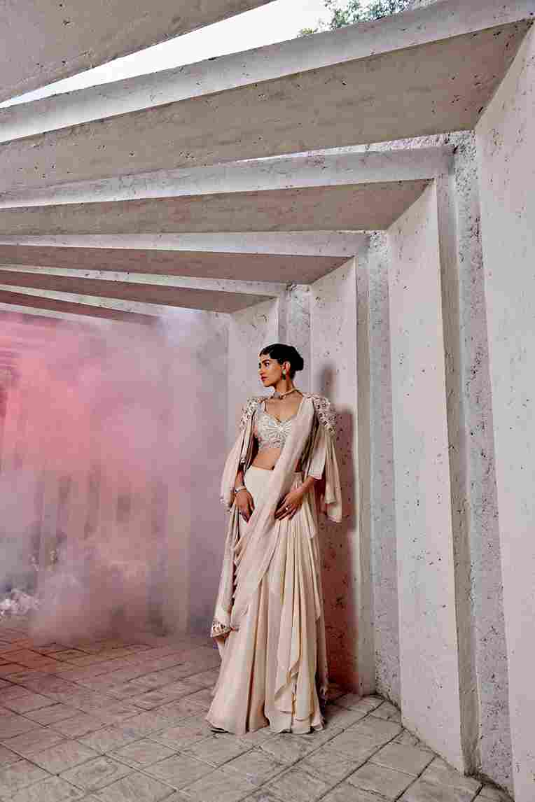 A model showcasing Double Draped Fish Lehenga by Miku Kumar from Miku Kumar's collection