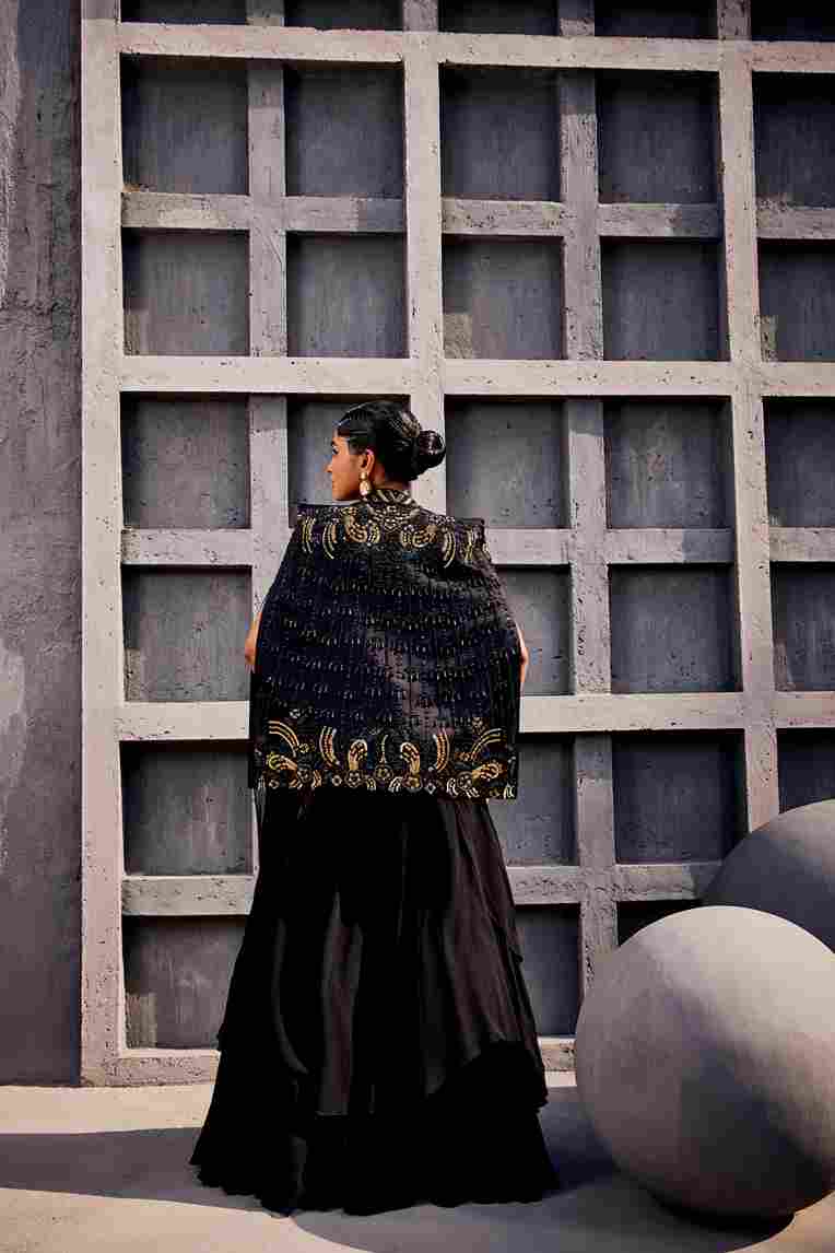 A model showcasing Black Draped Saree Lehenga by Miku Kumar from Miku Kumar's collection