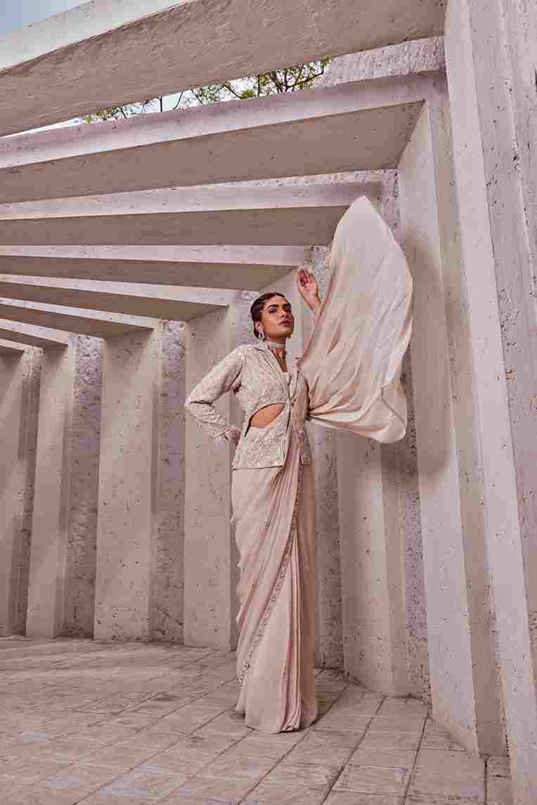 A model showcasing Ivory Stitched Saree by Miku Kumar from Miku Kumar's collection