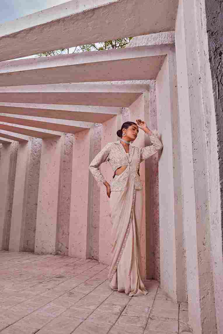 A model showcasing Ivory Stitched Saree by Miku Kumar from Miku Kumar's collection