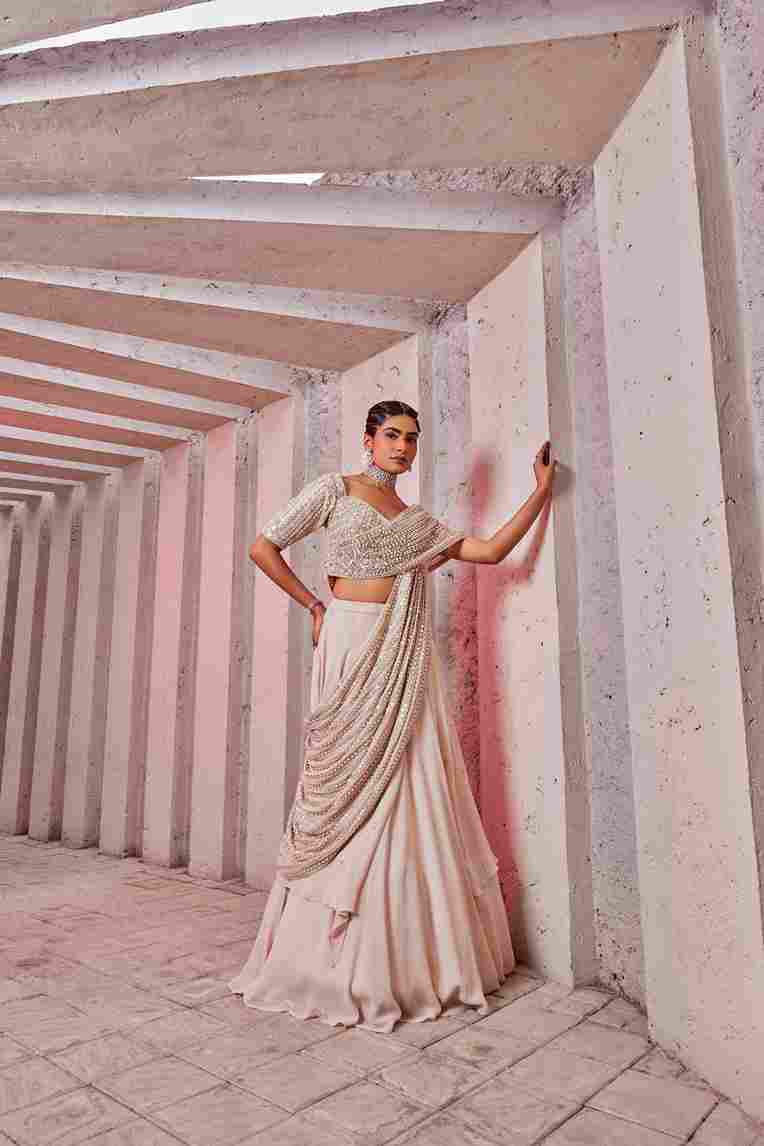 A model showcasing Draped Lahenga Choli by Miku Kumar from Miku Kumar's collection