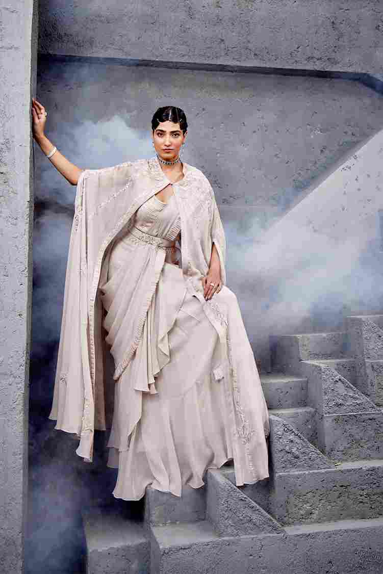 A model showcasing Ivory Ruffle Saree by Miku Kumar from Miku Kumar's collection