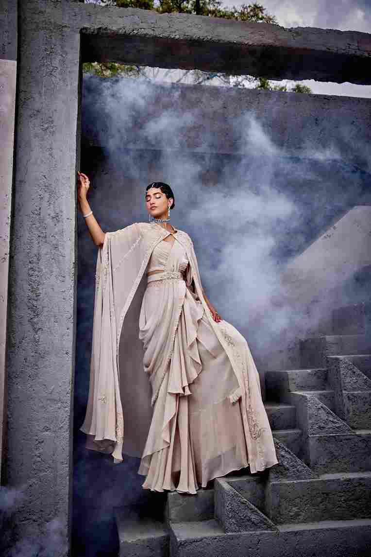 A model showcasing Ivory Ruffle Saree by Miku Kumar from Miku Kumar's collection