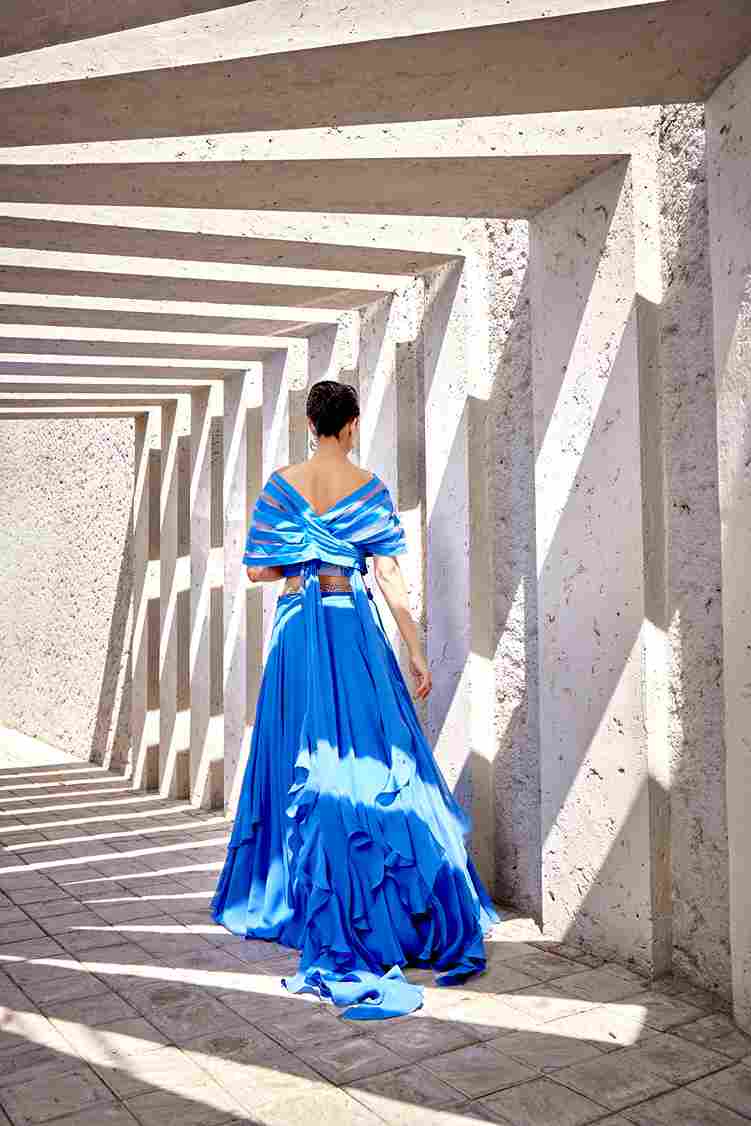 A model showcasing Blue Long Skirt With Layered Blouse by Miku Kumar from Miku Kumar's collection