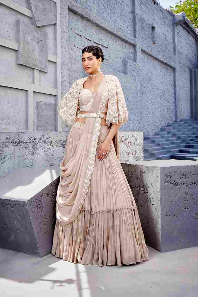 A model showcasing Corset Blouse Lehenga by Miku Kumar from Miku Kumar's collection