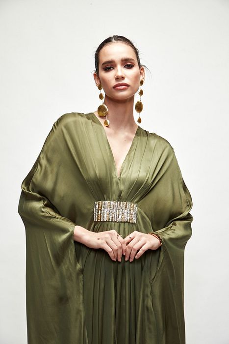 A model showcasing Olive Green Silk Kaftaan by Ranian from Ranian's collection A model showcasing Olive Green Silk Kaftaan by Ranian from Ranian's collection