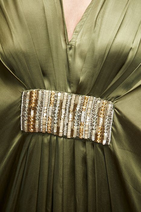 A model showcasing Olive Green Silk Kaftaan by Ranian from Ranian's collection A model showcasing Olive Green Silk Kaftaan by Ranian from Ranian's collection