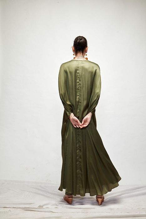 A model showcasing Olive Green Silk Kaftaan by Ranian from Ranian's collection A model showcasing Olive Green Silk Kaftaan by Ranian from Ranian's collection