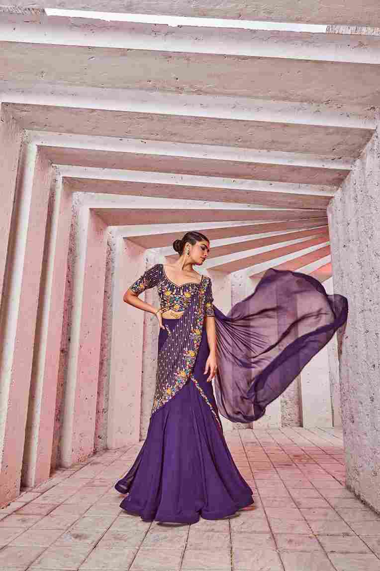 A model showcasing Purple Draped Saree by Miku Kumar from Miku Kumar's collection A model showcasing Purple Draped Saree by Miku Kumar from Miku Kumar's collection