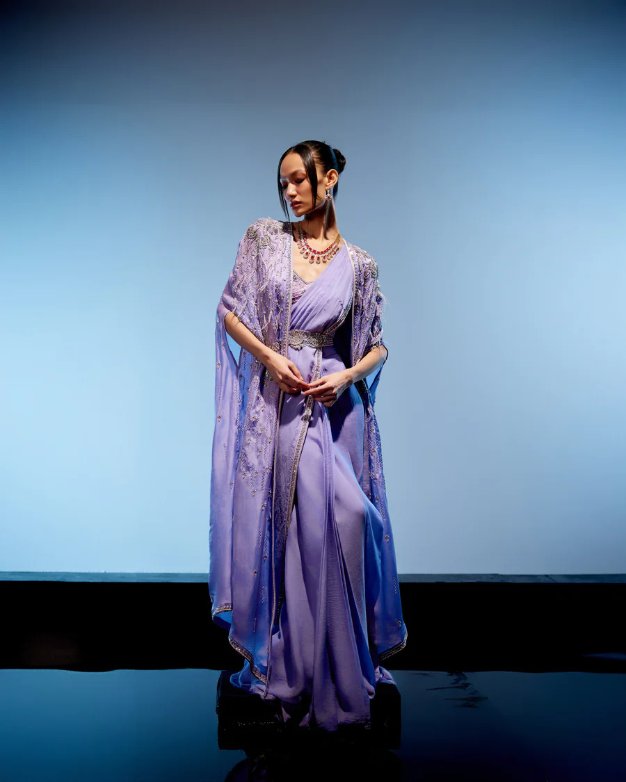 A model showcasing Orchid Drape Saree by Miku Kumar from Miku Kumar's collection
