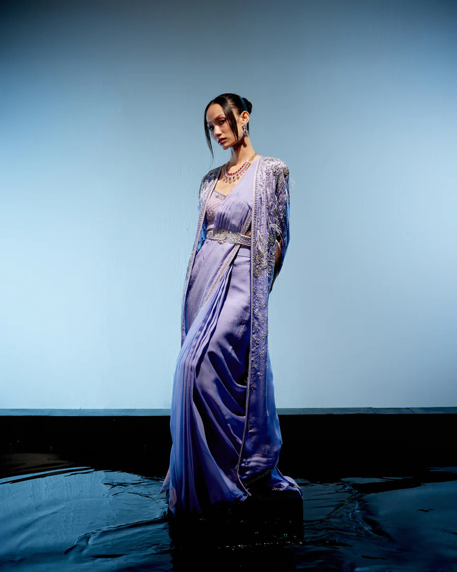 A model showcasing Orchid Drape Saree by Miku Kumar from Miku Kumar's collection