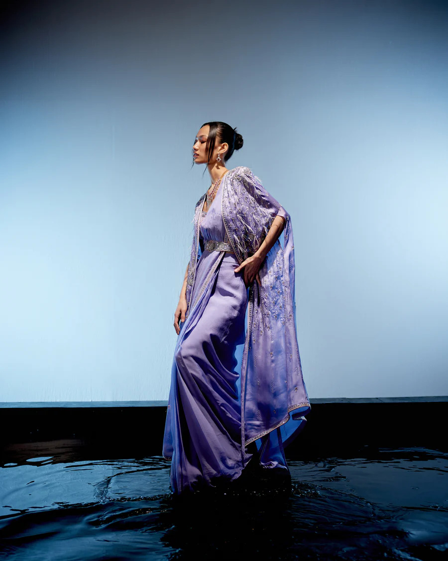 A model showcasing Orchid Drape Saree by Miku Kumar from Miku Kumar's collection