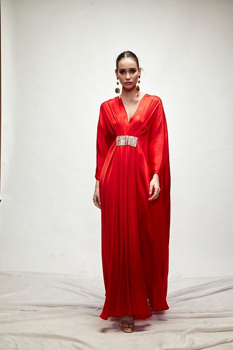 A model showcasing Red Silk Kaftaan by Ranian from Ranian's collection A model showcasing Red Silk Kaftaan by Ranian from Ranian's collection