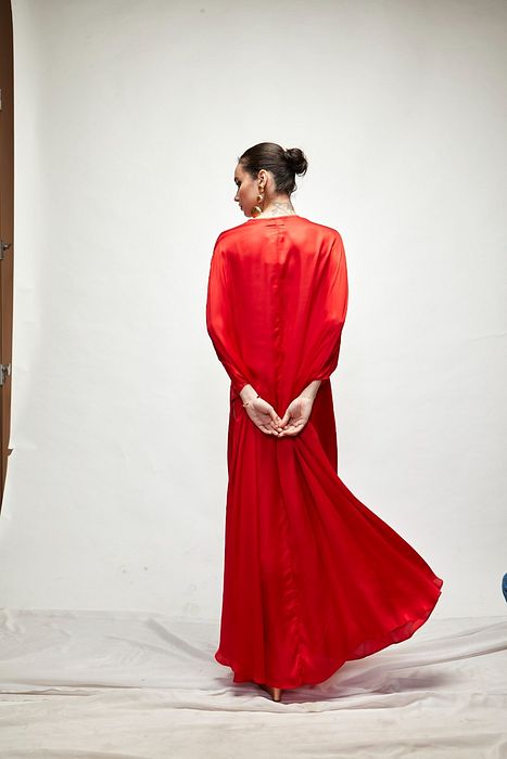 A model showcasing Red Silk Kaftaan by Ranian from Ranian's collection A model showcasing Red Silk Kaftaan by Ranian from Ranian's collection