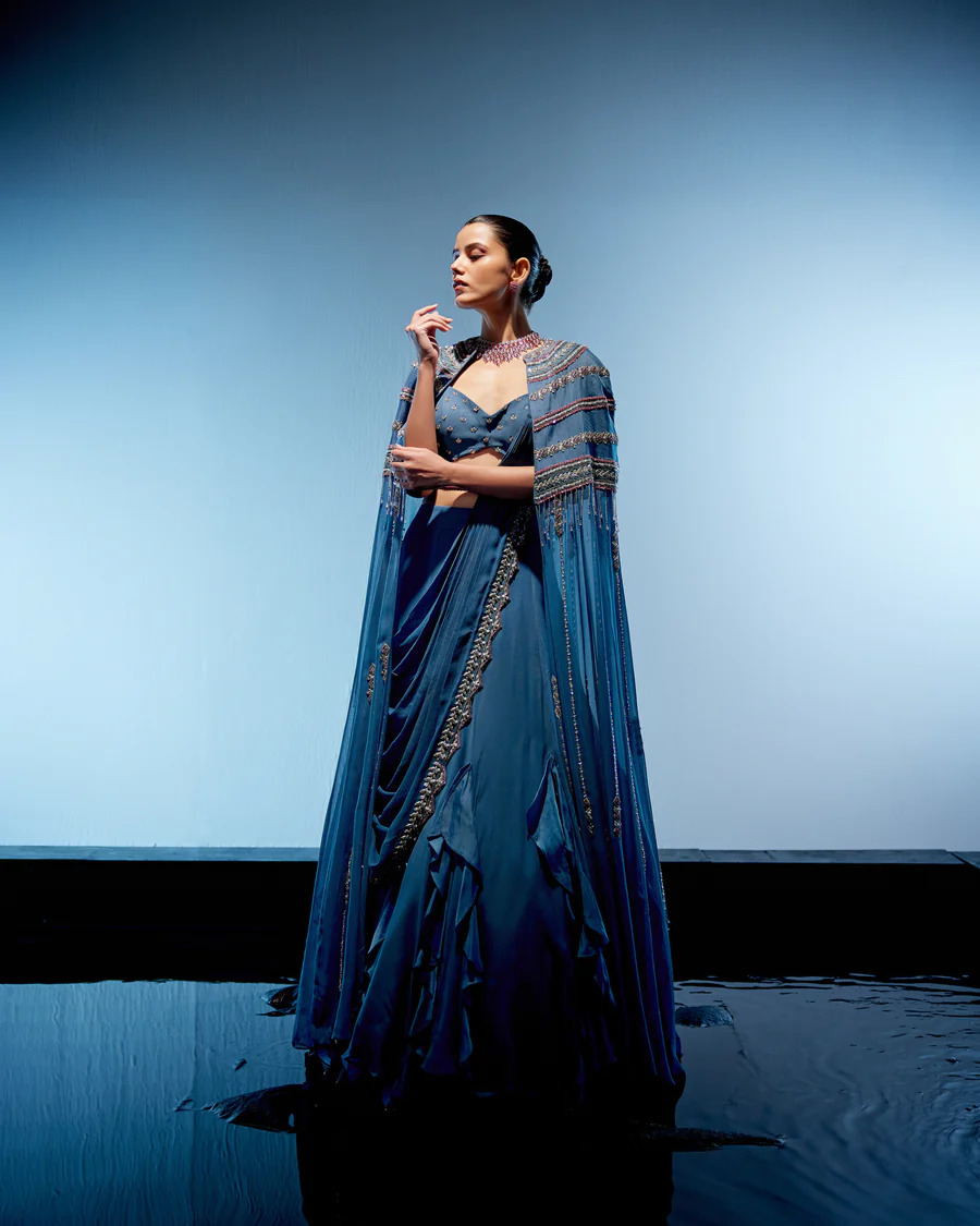 A model showcasing Blue Evelyn Lehenga by Miku Kumar from Miku Kumar's collection