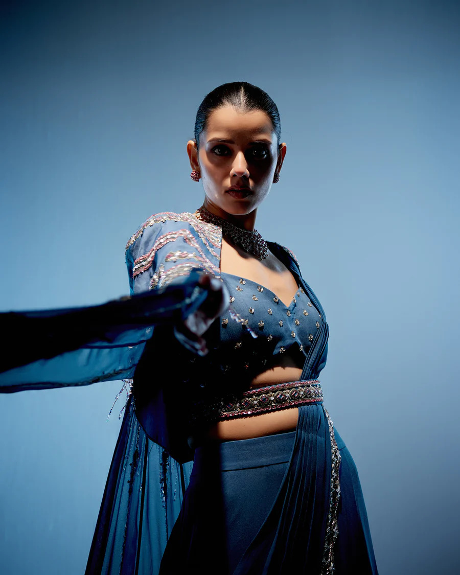 A model showcasing Blue Evelyn Lehenga by Miku Kumar from Miku Kumar's collection