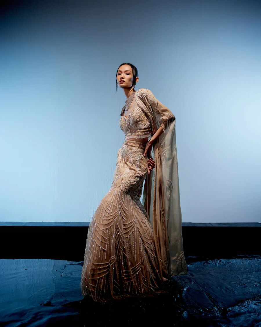 A model showcasing Ivory Bianca Lehenga by Miku Kumar from Miku Kumar's collection