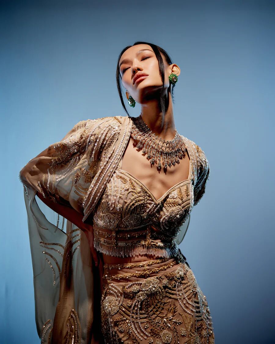 A model showcasing Ivory Bianca Lehenga by Miku Kumar from Miku Kumar's collection