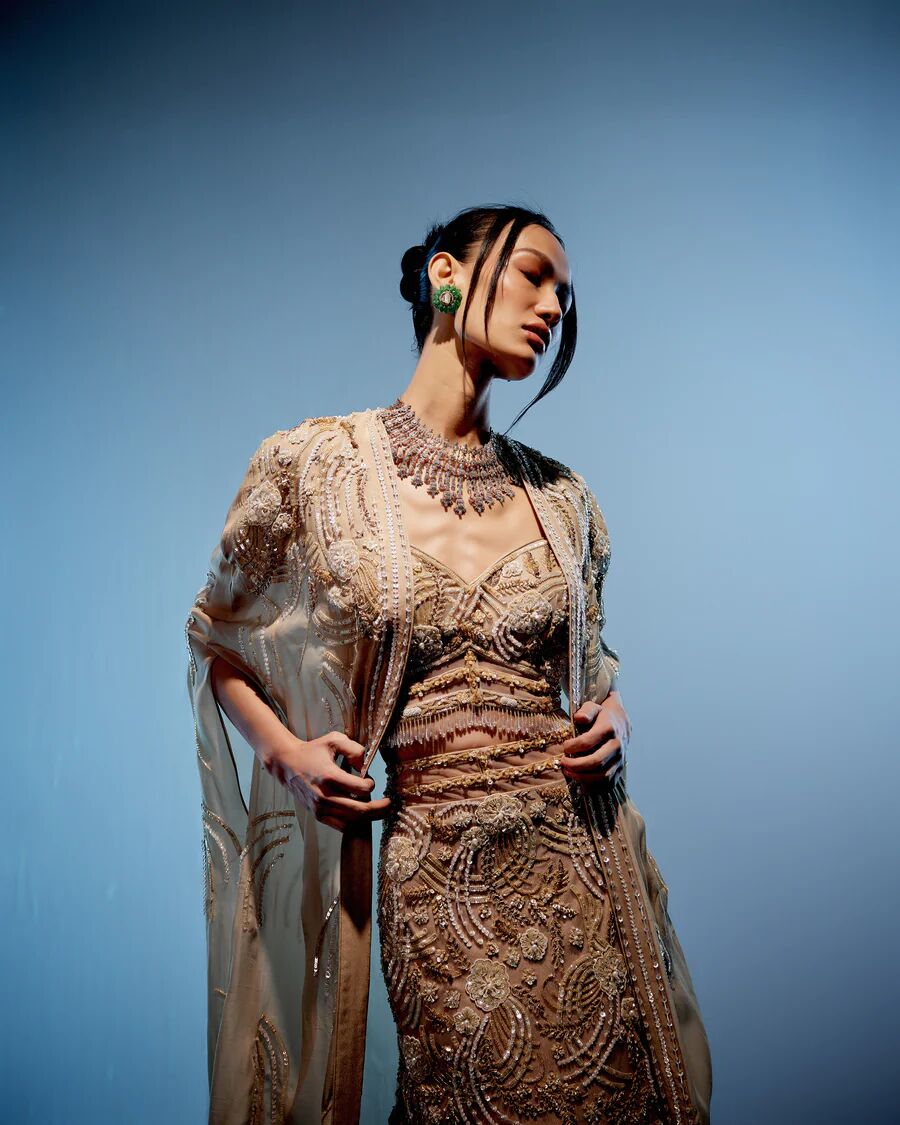 A model showcasing Ivory Bianca Lehenga by Miku Kumar from Miku Kumar's collection