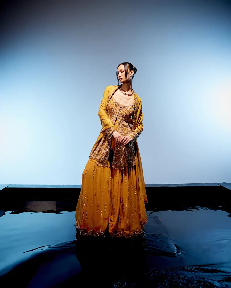A model showcasing Aurelia Sharara Set by Miku Kumar from Miku Kumar's collection