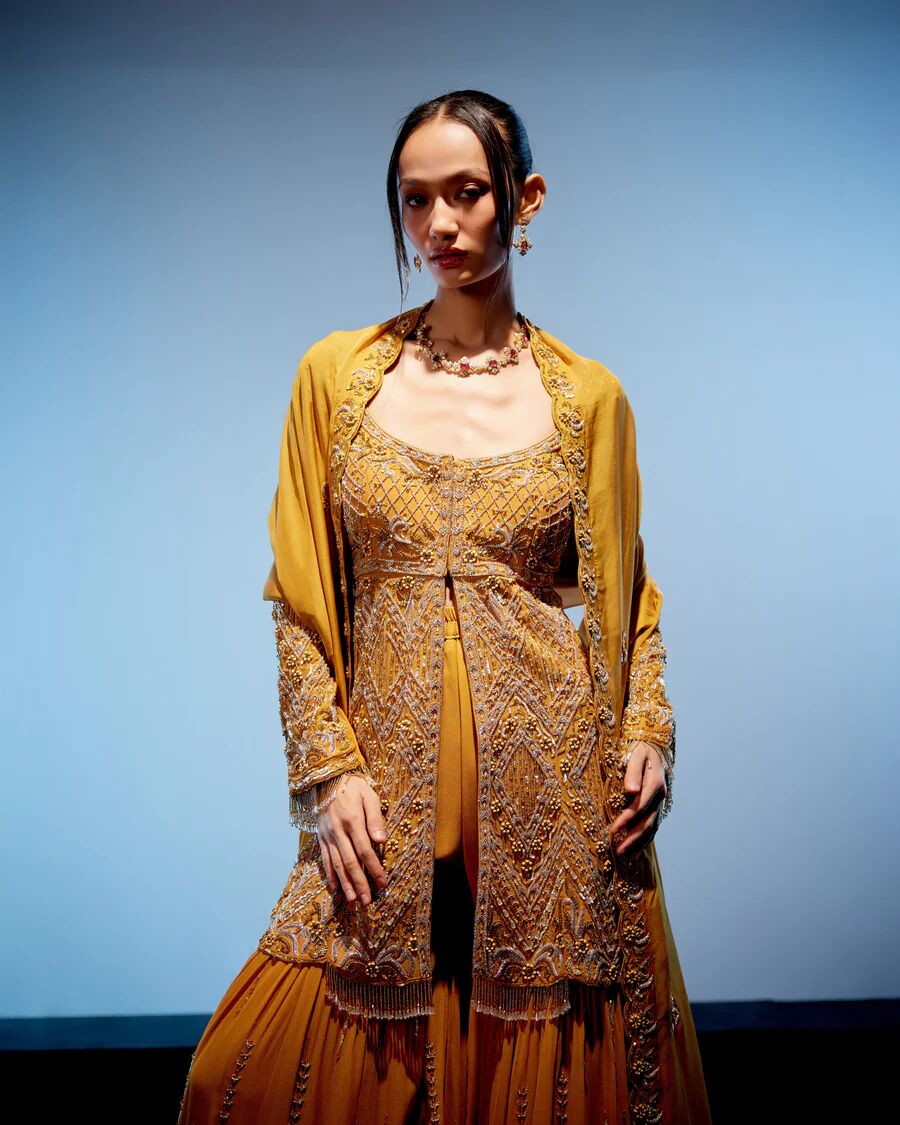 A model showcasing Aurelia Sharara Set by Miku Kumar from Miku Kumar's collection