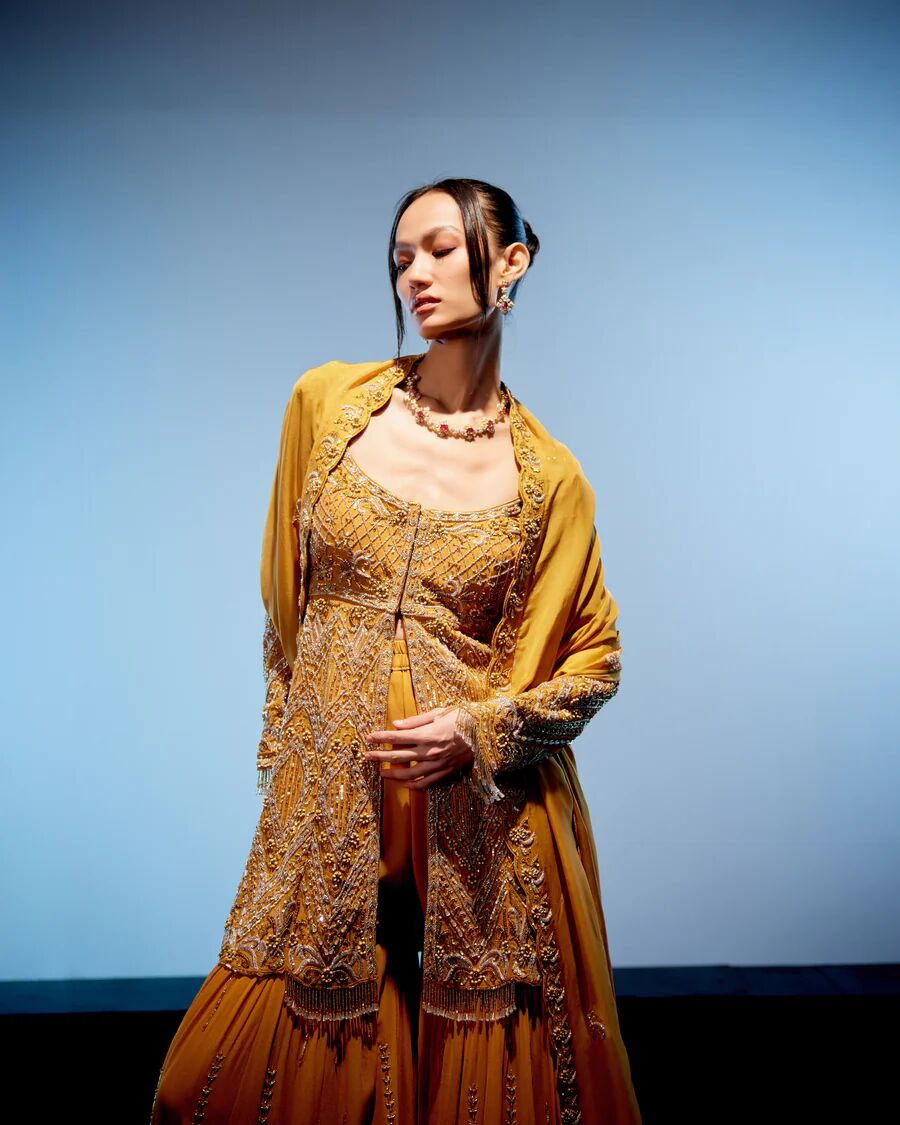 A model showcasing Aurelia Sharara Set by Miku Kumar from Miku Kumar's collection