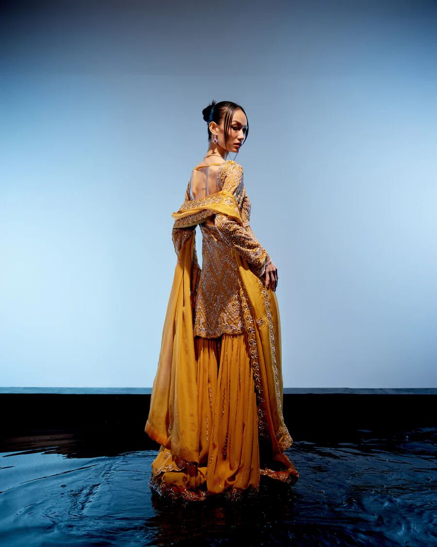 A model showcasing Aurelia Sharara Set by Miku Kumar from Miku Kumar's collection