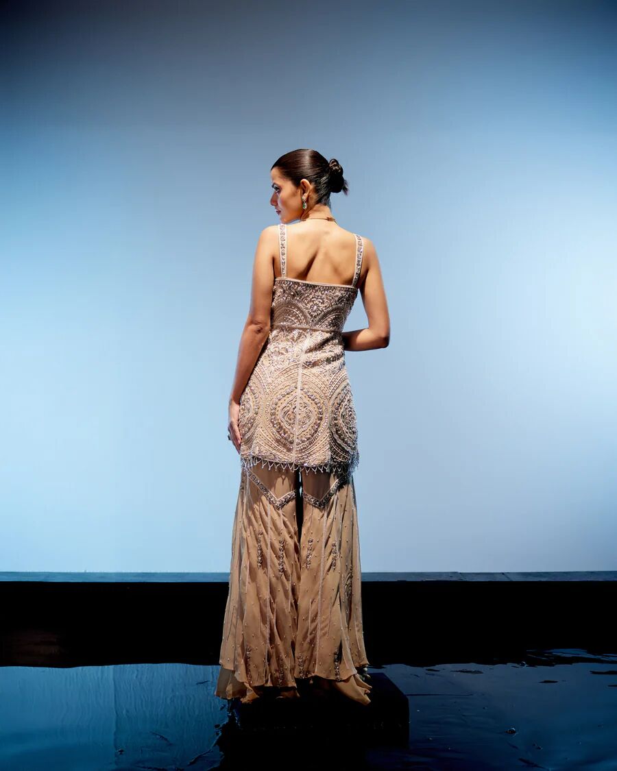 A model showcasing Valerie Sharara Set by Miku Kumar from Miku Kumar's collection