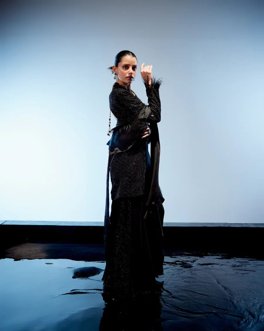A model showcasing Raven Sharara Set by Miku Kumar from Miku Kumar's collection