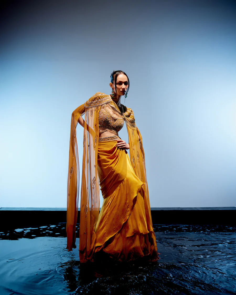 A model showcasing Amber Cape Skirt Set by Miku Kumar from Miku Kumar's collection