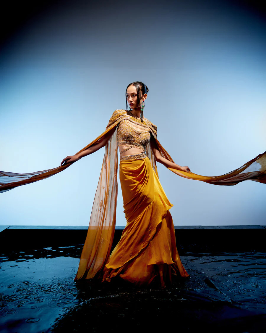 A model showcasing Amber Cape Skirt Set by Miku Kumar from Miku Kumar's collection