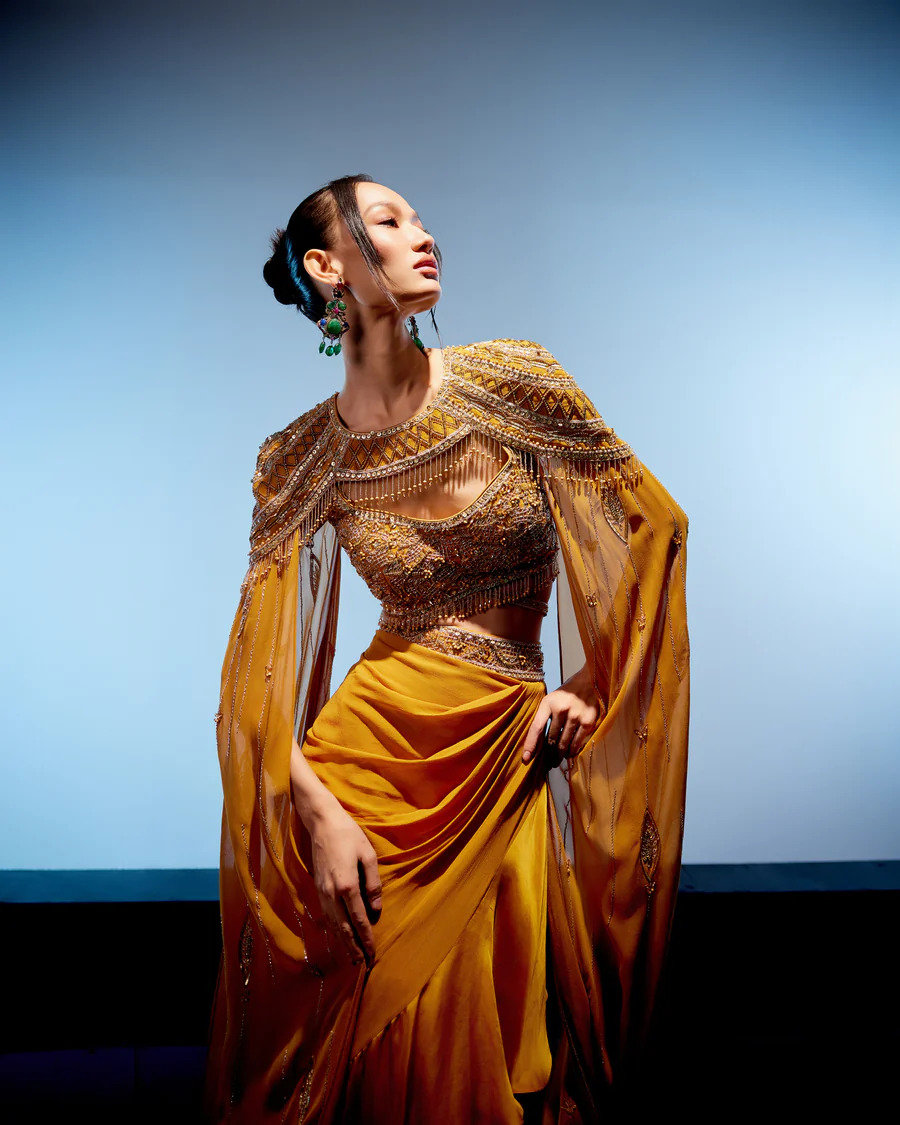 A model showcasing Amber Cape Skirt Set by Miku Kumar from Miku Kumar's collection