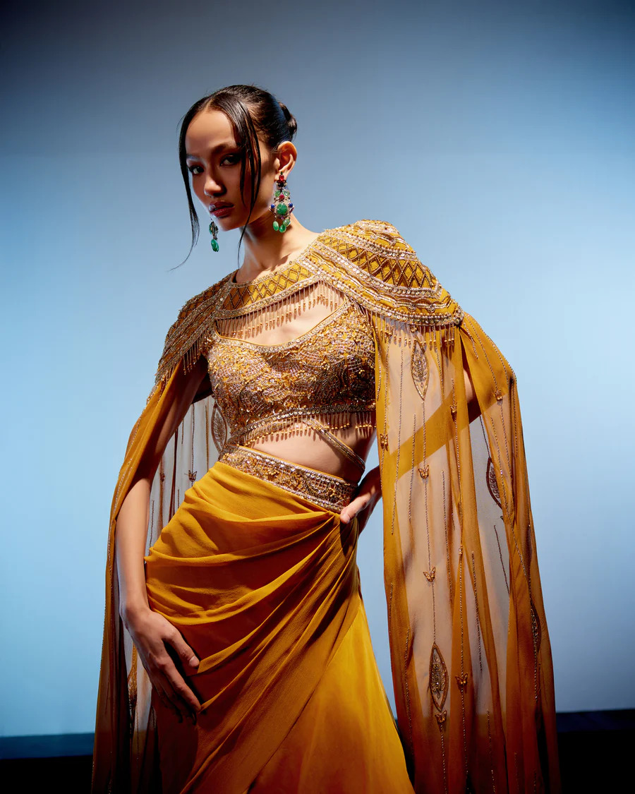 A model showcasing Amber Cape Skirt Set by Miku Kumar from Miku Kumar's collection