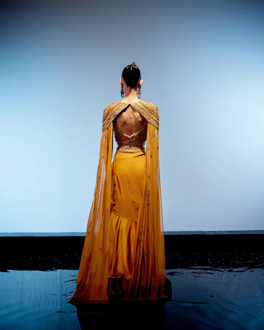 A model showcasing Amber Cape Skirt Set by Miku Kumar from Miku Kumar's collection