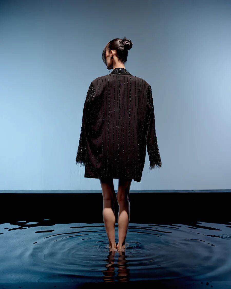A model showcasing Black Ebony Jacket Dress by Miku Kumar from Miku Kumar's collection