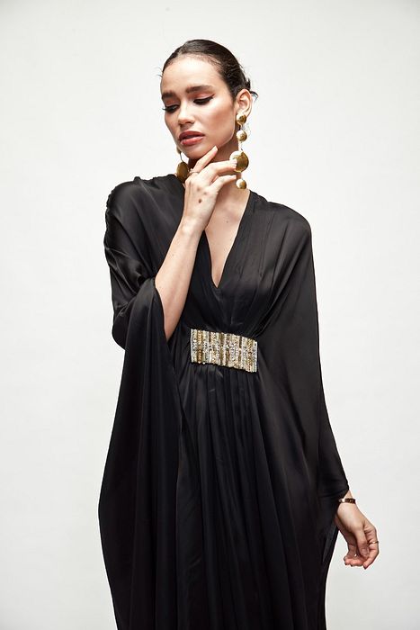 A model showcasing Black Silk Kaftaan by Ranian from Ranian's collection A model showcasing Black Silk Kaftaan by Ranian from Ranian's collection