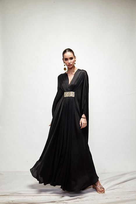 A model showcasing Black Silk Kaftaan by Ranian from Ranian's collection A model showcasing Black Silk Kaftaan by Ranian from Ranian's collection