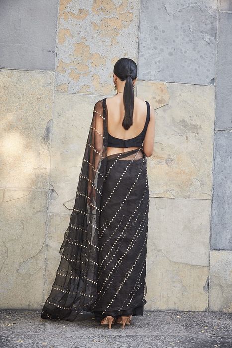 A model showcasing Black Silk Organza Saree by Ranian from Ranian's collection A model showcasing Black Silk Organza Saree by Ranian from Ranian's collection