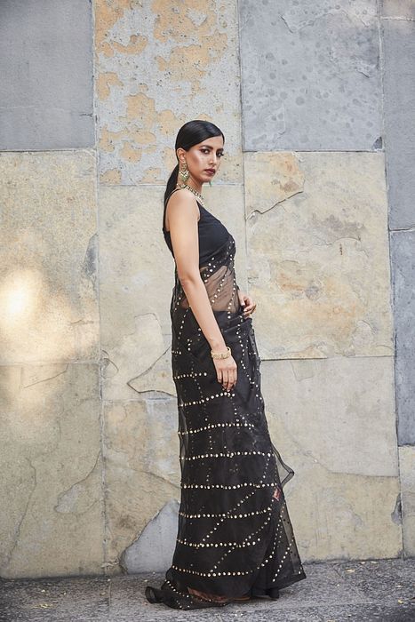 A model showcasing Black Silk Organza Saree by Ranian from Ranian's collection A model showcasing Black Silk Organza Saree by Ranian from Ranian's collection