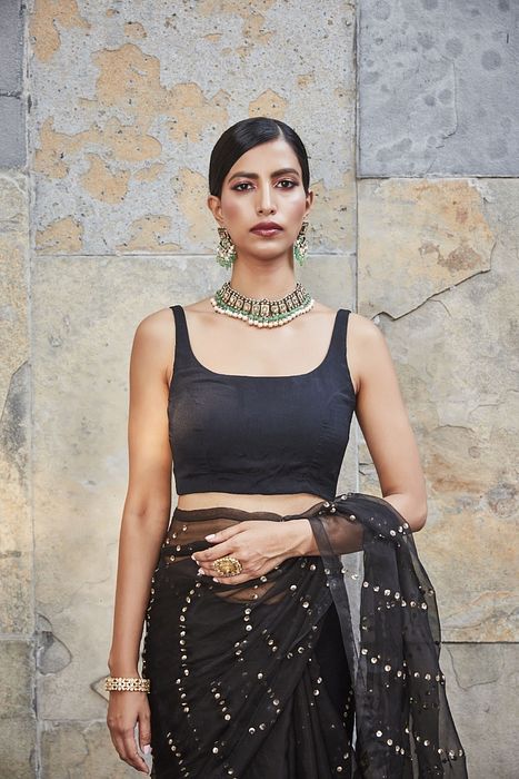 A model showcasing Black Silk Organza Saree by Ranian from Ranian's collection A model showcasing Black Silk Organza Saree by Ranian from Ranian's collection